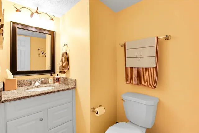 a bedroom with a bed and a wooden floor