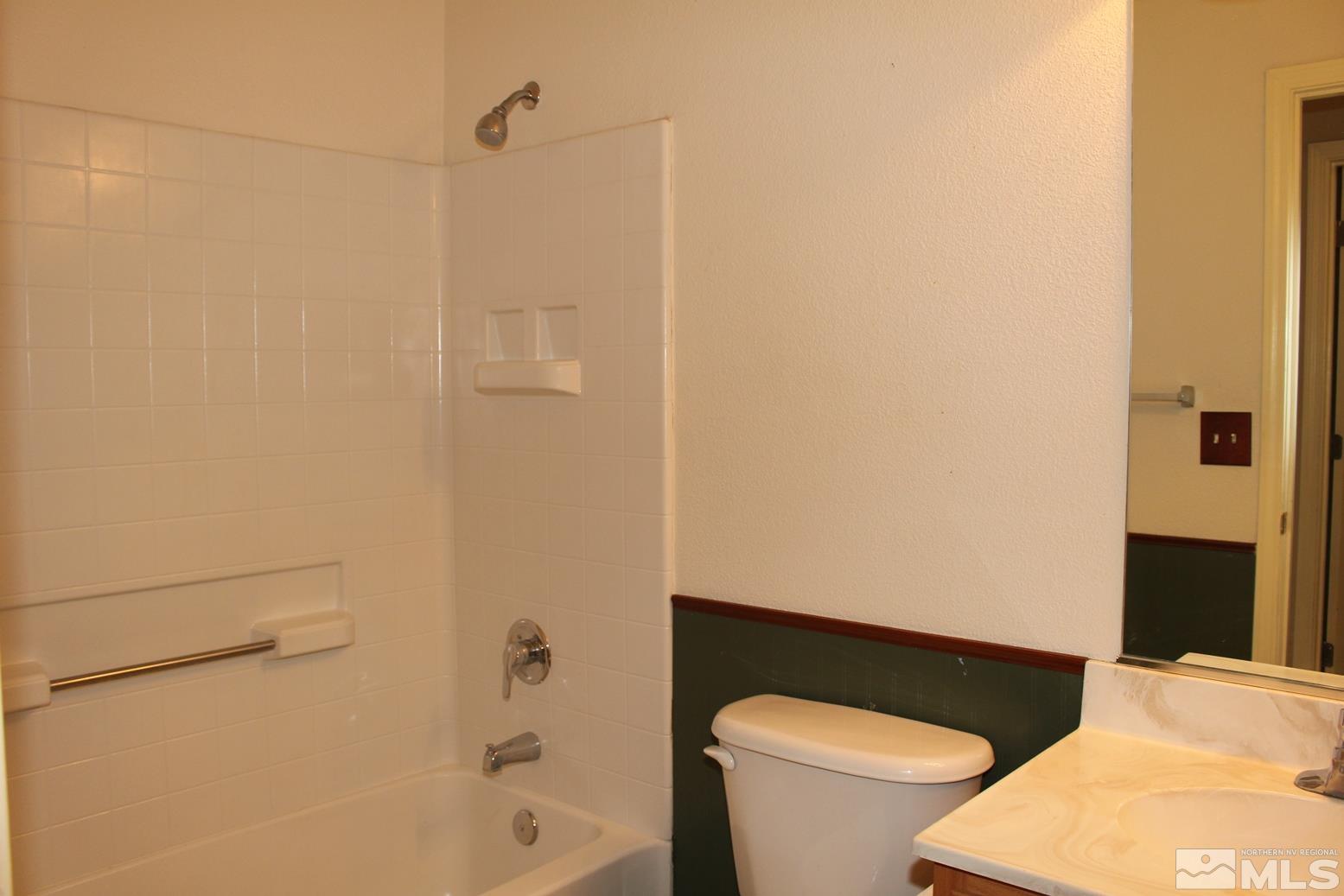 100 Calistoga Court Reno, NV 89508 - Photo 21 of 40 a white toilet sitting next to a bath tub