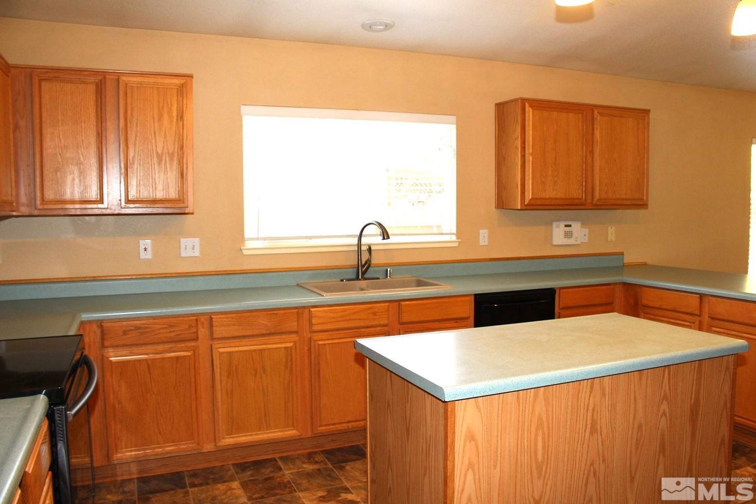 100 Calistoga Court Reno, NV 89508 - Photo 8 of 40 a kitchen with a sink cabinets and a window