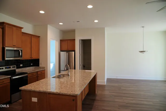 a kitchen with stainless steel appliances granite countertop a sink a microwave counter space and cabinets