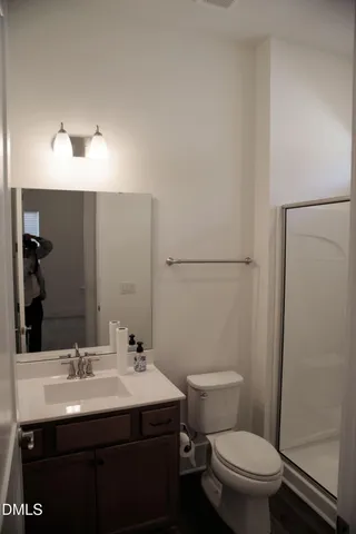 a bathroom with a sink toilet and a mirror
