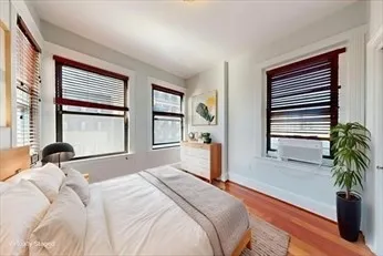 a bedroom with a bed and a large window with outer view