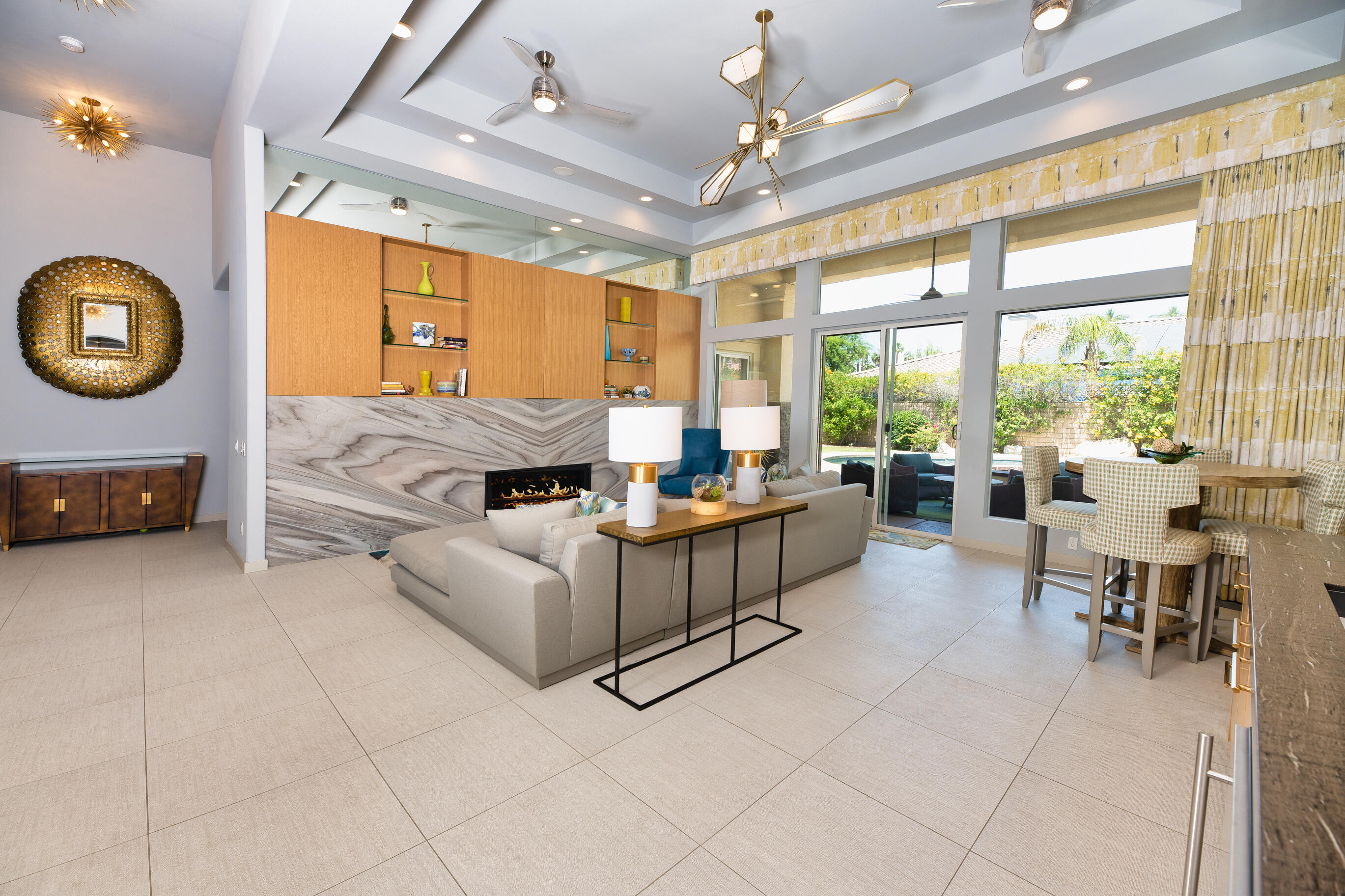 12 Varsity Circle Rancho Mirage, CA 92270 - Photo 2 of 70 a living room with furniture a flat screen tv and a large window