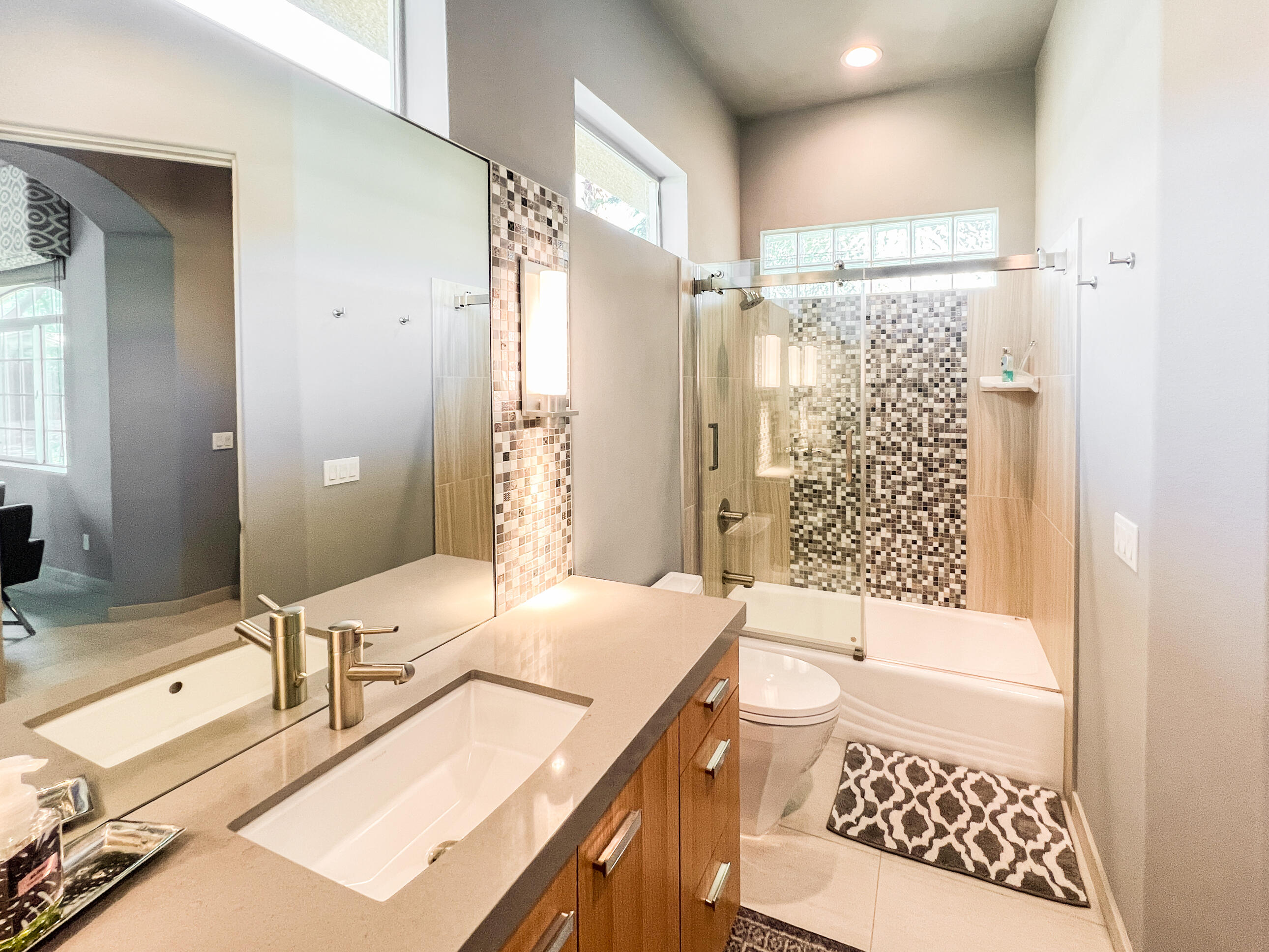 12 Varsity Circle Rancho Mirage, CA 92270 - Photo 56 of 70 a bathroom with a granite countertop sink a toilet a mirror a vanity and shower