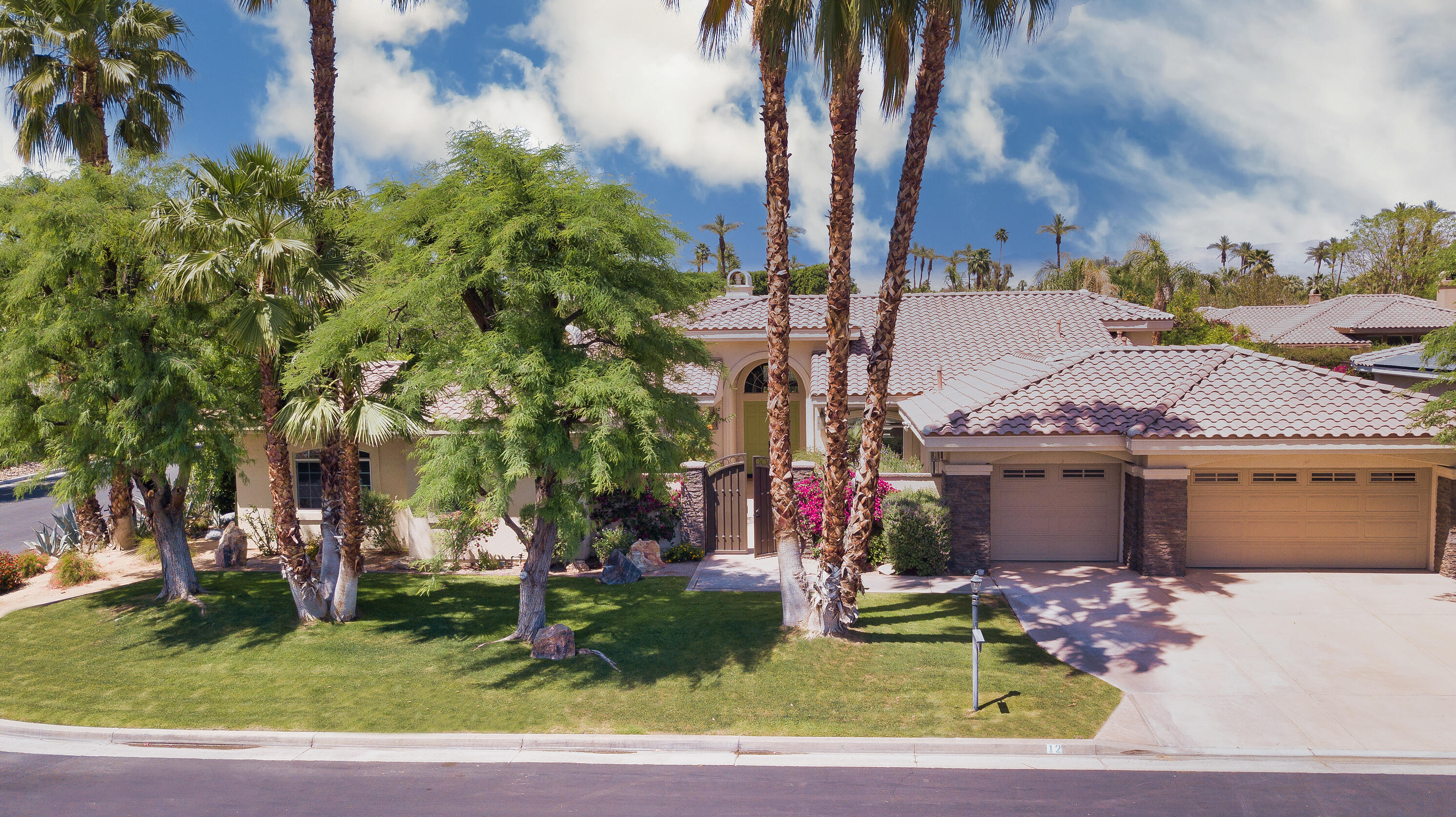 12 Varsity Circle Rancho Mirage, CA 92270 - Photo 66 of 70 a front view of a house with garden