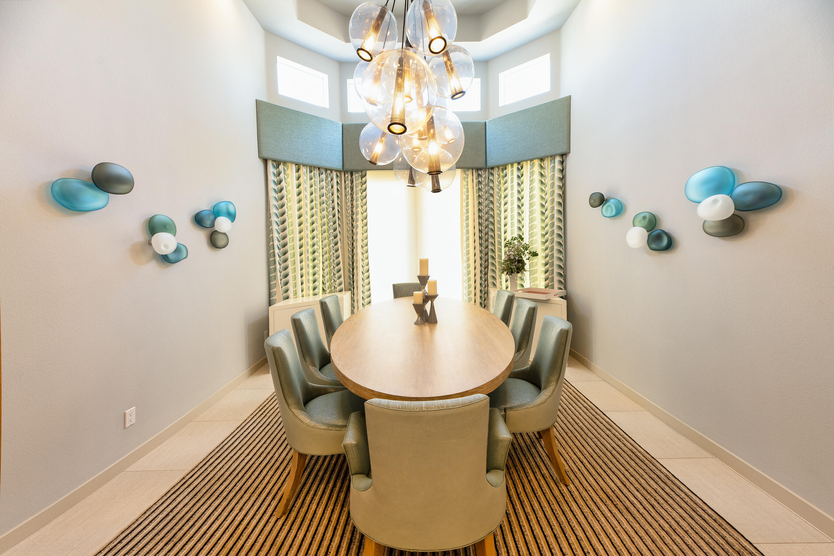 12 Varsity Circle Rancho Mirage, CA 92270 - Photo 9 of 70 a dining room with chandelier fan and wooden floor