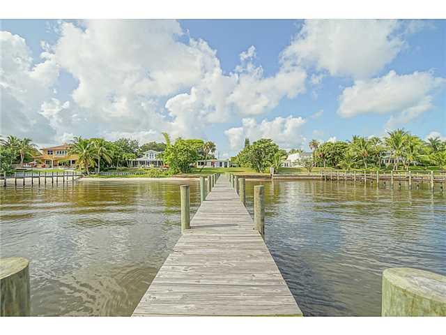 1041 Southeast Riverside Drive Stuart, FL 34996 - Photo 18 of 25 a wooden pier with boats and a lake view