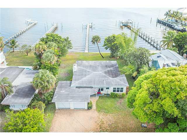1041 Southeast Riverside Drive Stuart, FL 34996 - Photo 19 of 25 a view of a house with a yard and potted plants