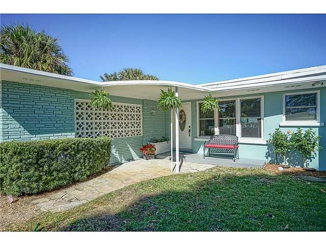 1041 Southeast Riverside Drive Stuart, FL 34996 - Photo 2 of 25 a view of a house with a yard balcony and wooden fence