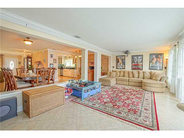 1041 Southeast Riverside Drive Stuart, FL 34996 - Photo 8 of 25 a living room with furniture large window and a table
