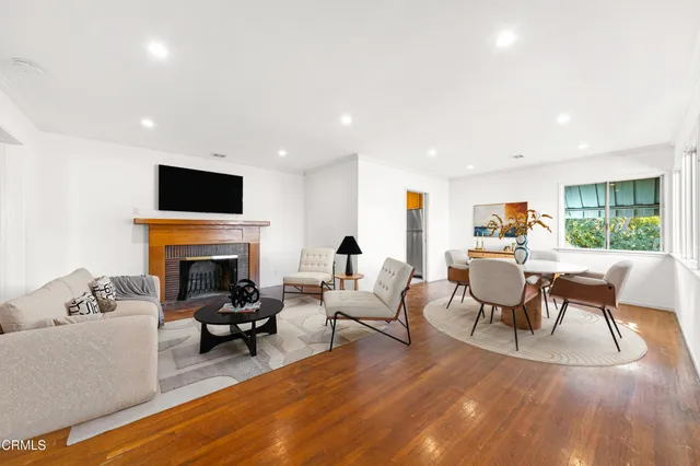 a living room with furniture a fireplace and a flat screen tv