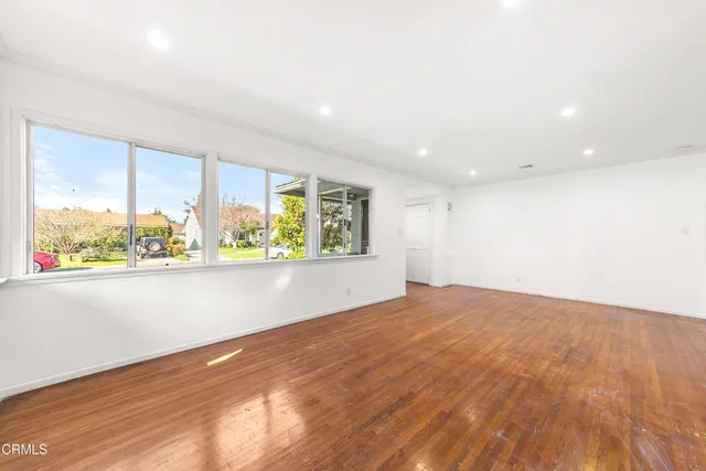 an empty room with large windows