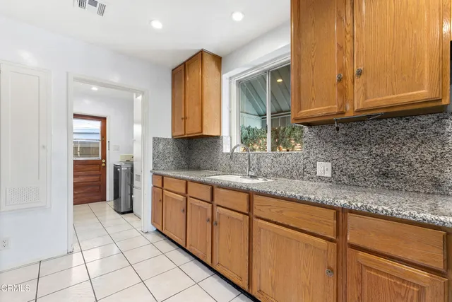 a kitchen with stainless steel appliances granite countertop a sink and cabinets