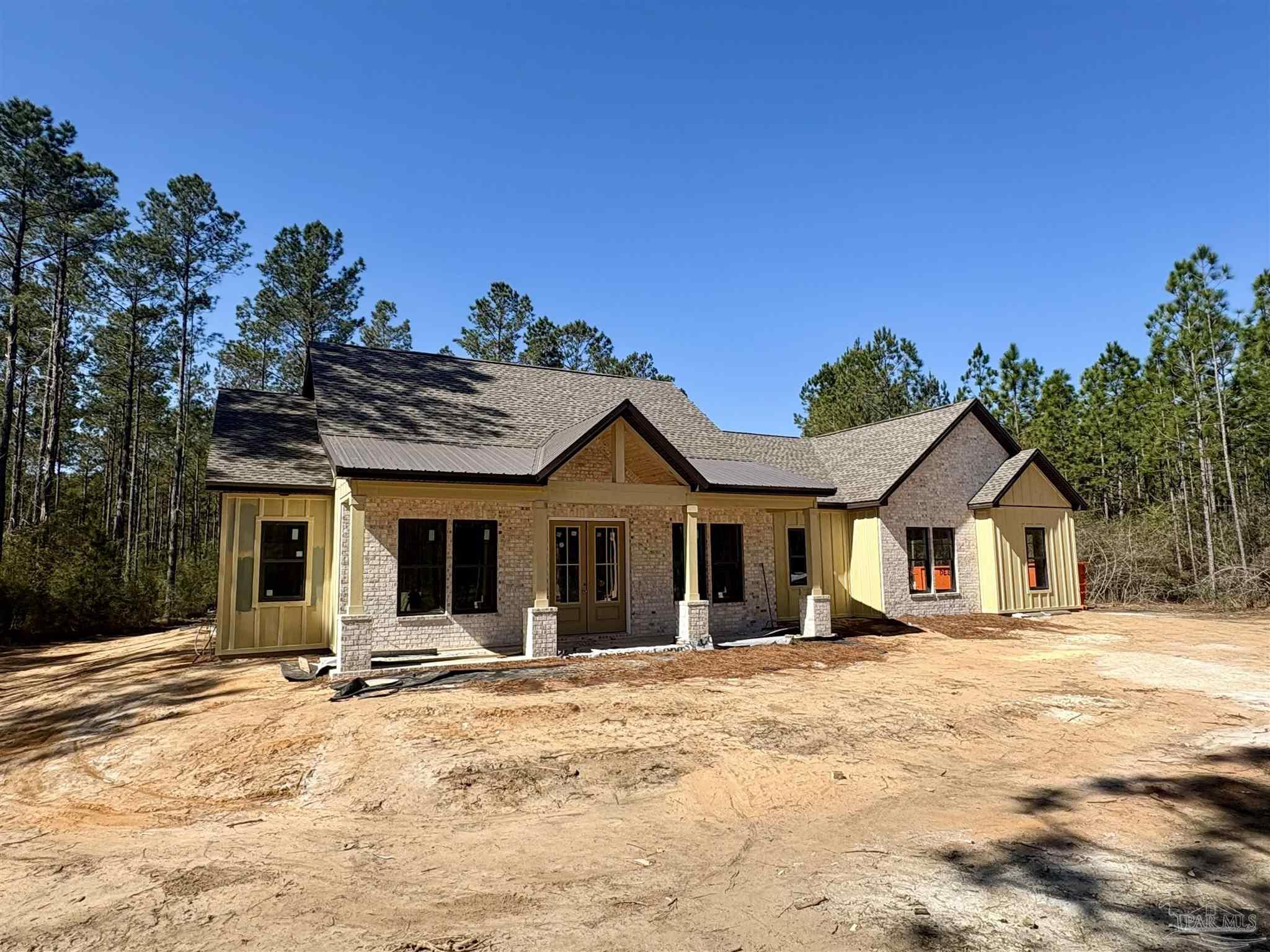 3571 Maple Branch Lane Milton, FL 32571 - Photo 2 of 6 a view of a white house with a large tree with yard