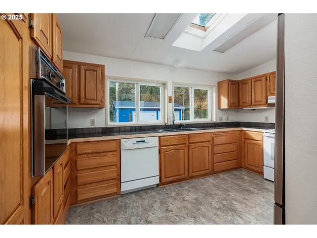 a kitchen with stainless steel appliances granite countertop a refrigerator sink and cabinets