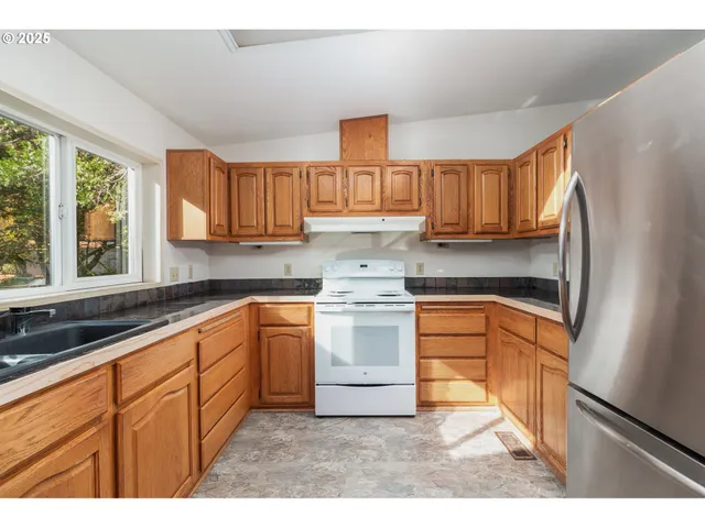 a kitchen sink sitting next to a window
