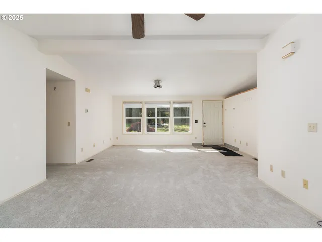 a view of a hallway with wooden floor and entryway