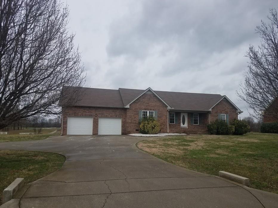 4686 Matthews Road Cedar Hill, TN 37032 - Photo 1 of 20 a front view of a house with a garden