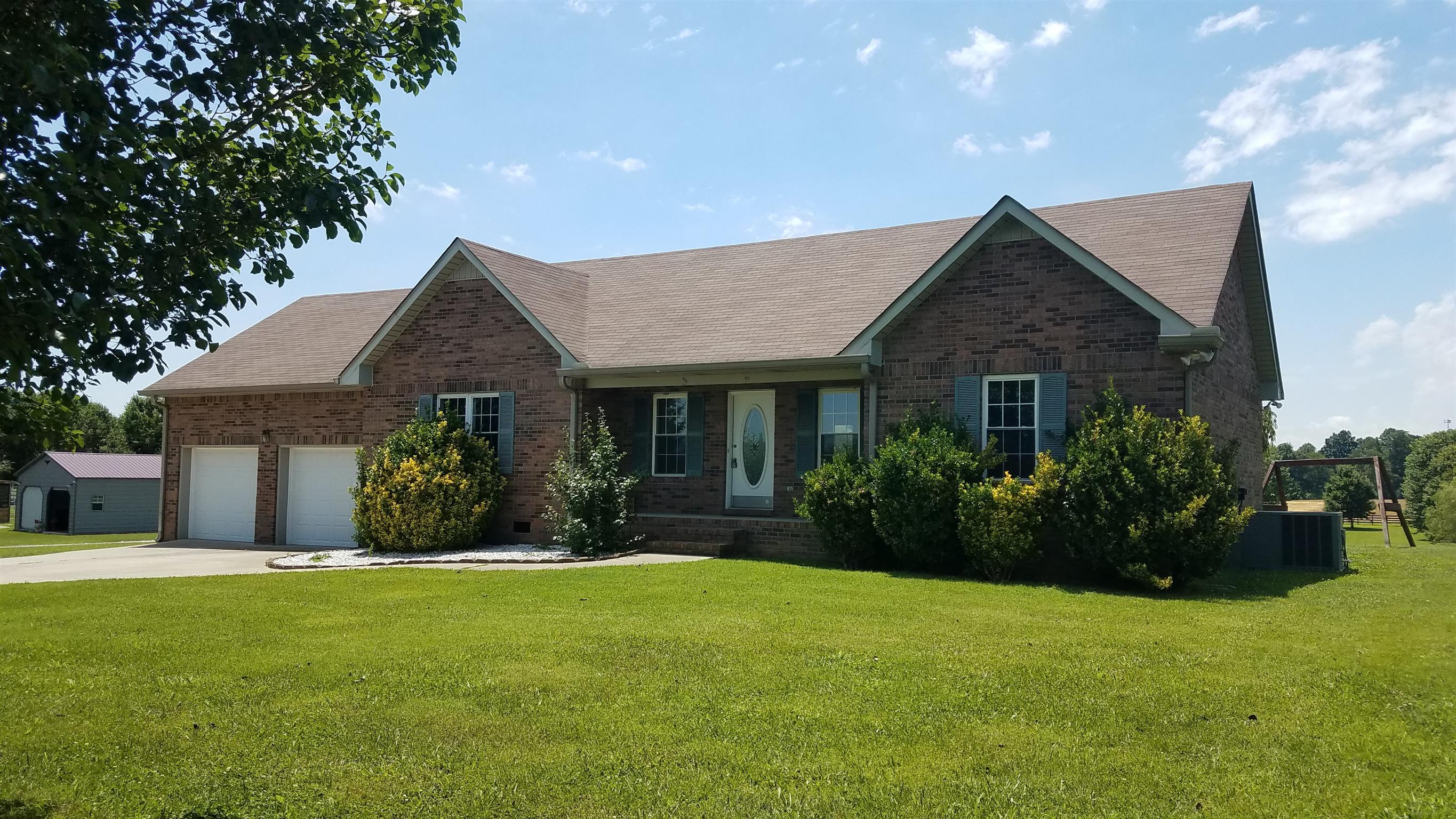 4686 Matthews Road Cedar Hill, TN 37032 - Photo 2 of 20 a front view of a house with a garden