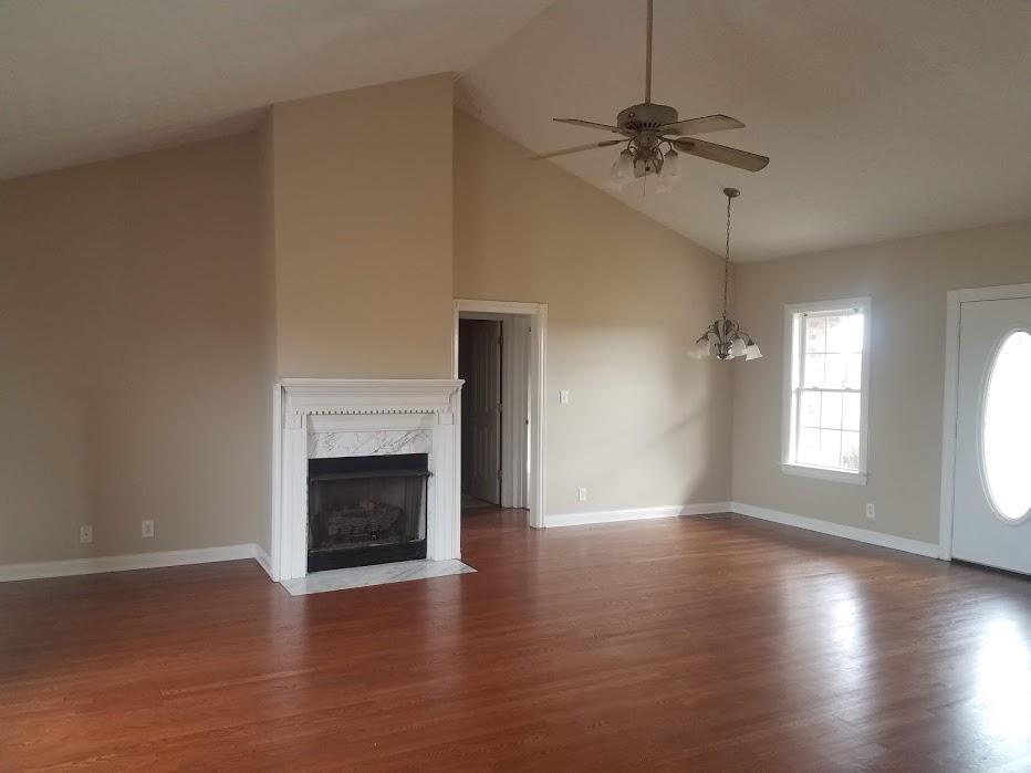 4686 Matthews Road Cedar Hill, TN 37032 - Photo 4 of 20 wooden floor fireplace and windows in an empty room