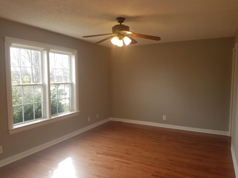4686 Matthews Road Cedar Hill, TN 37032 - Photo 7 of 20 a view of wooden floor and windows in a room