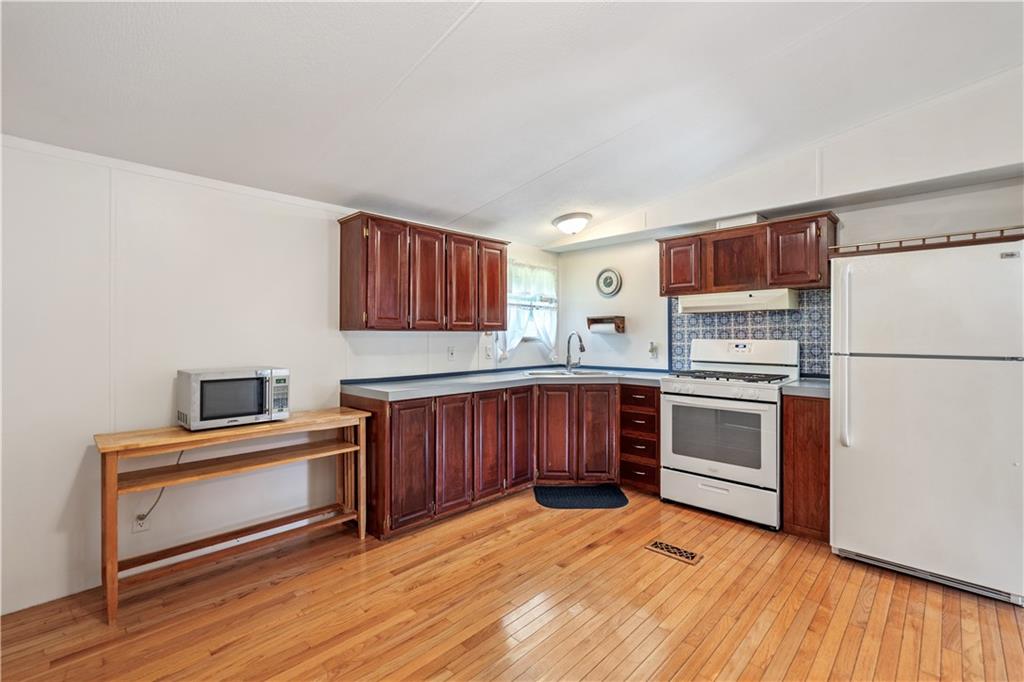 14 Belgium Hill Road Cecil, PA 15321 - Photo 4 of 16 a kitchen with stainless steel appliances granite countertop a refrigerator sink and stove