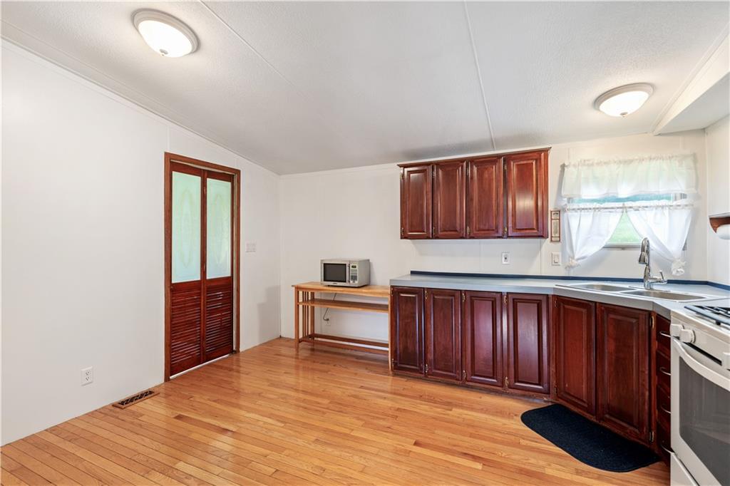 14 Belgium Hill Road Cecil, PA 15321 - Photo 5 of 16 a kitchen with granite countertop wooden cabinets and wooden floor