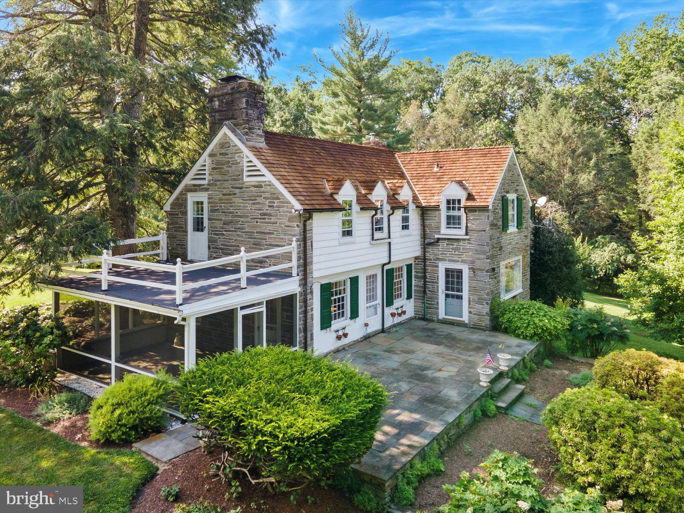 a aerial view of a house with a yard and potted plants