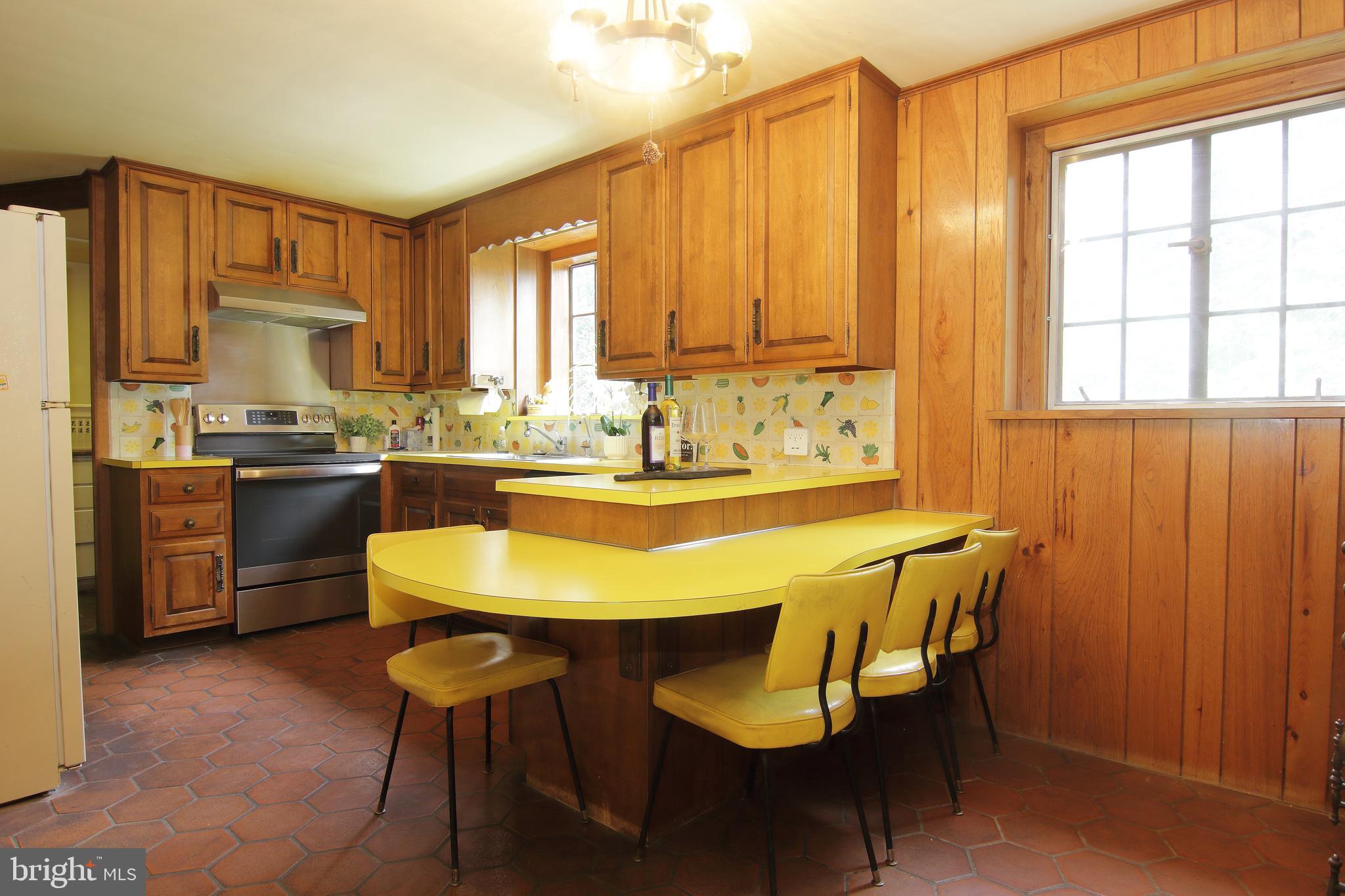 409 Marple Road Broomall, PA 19008 - Photo 16 of 37 a kitchen with a table chairs sink and cabinets