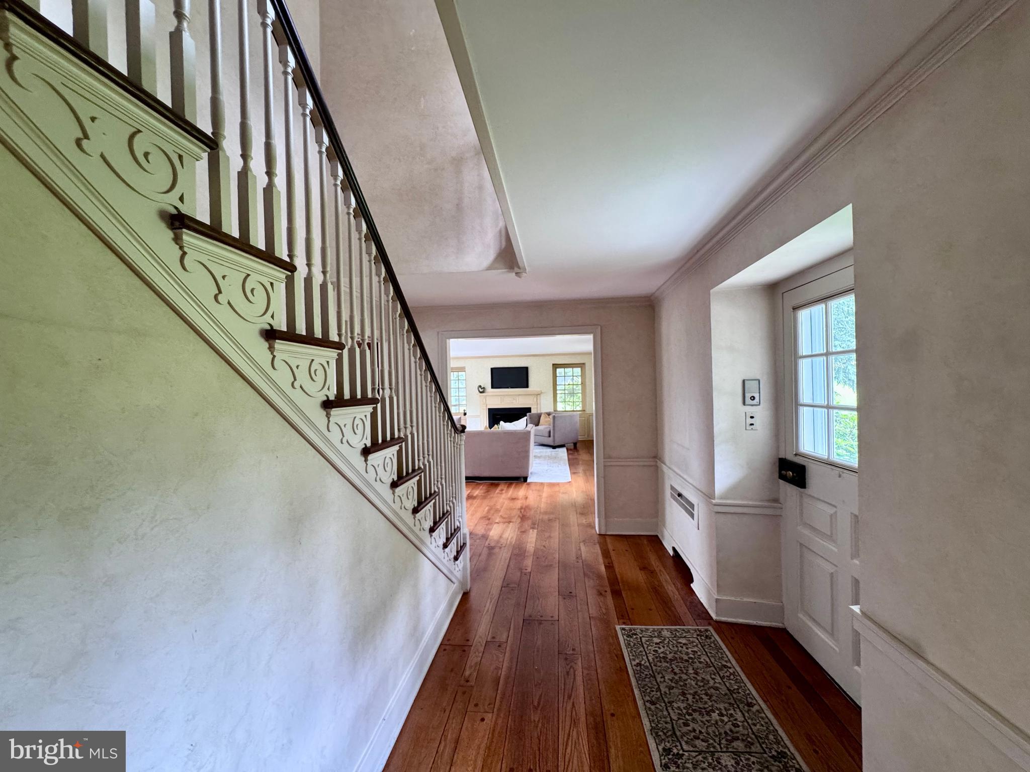 409 Marple Road Broomall, PA 19008 - Photo 23 of 37 a view of a hallway with wooden floor and stairs