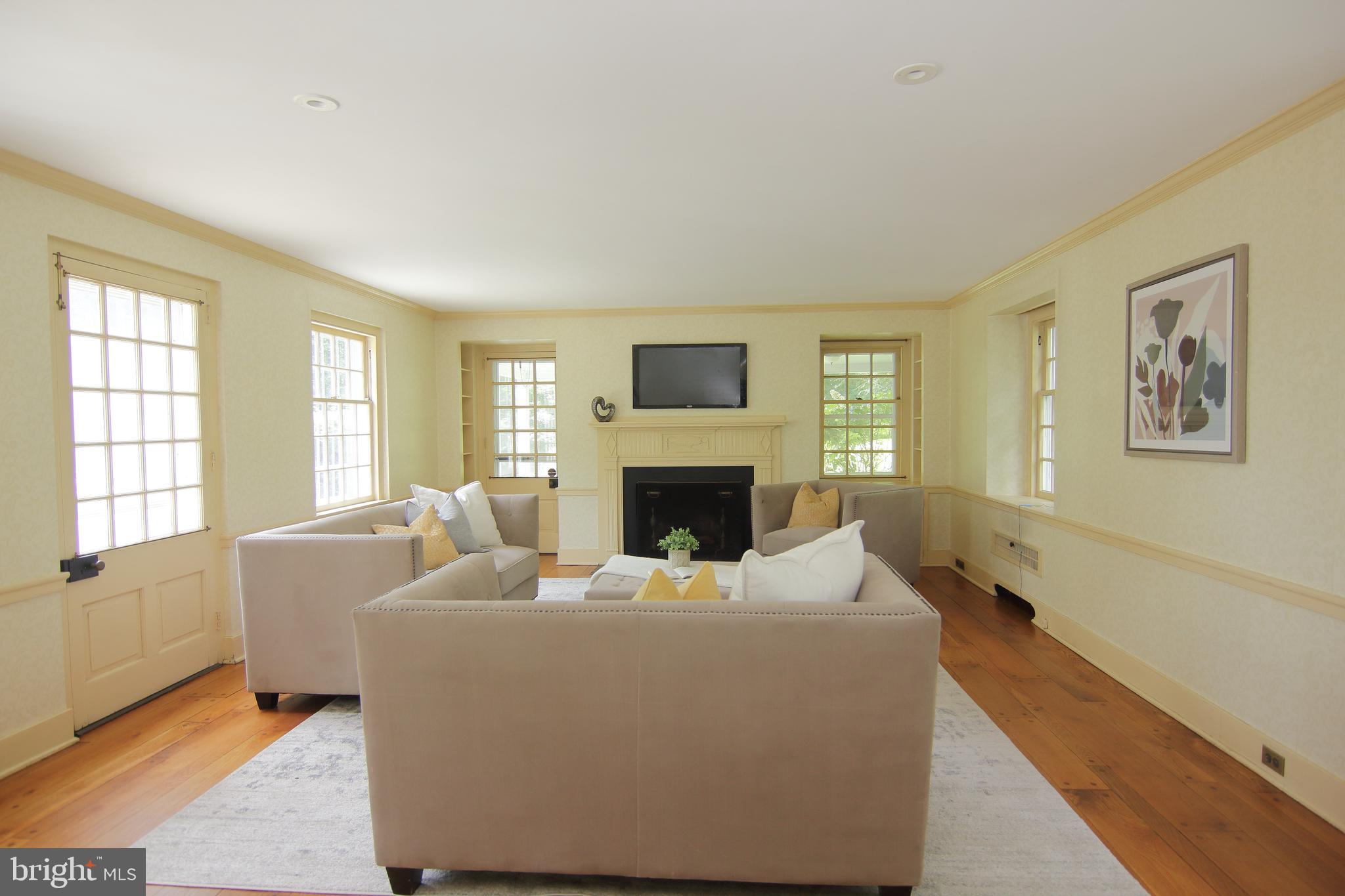 409 Marple Road Broomall, PA 19008 - Photo 6 of 37 a living room with furniture window and a fireplace