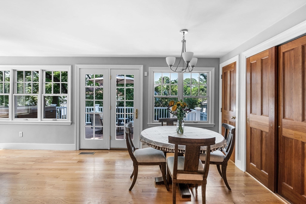 22 Robbins Road Watertown, MA 02472 - Photo 18 of 30 a dining room with furniture window wooden floor and a chandelier