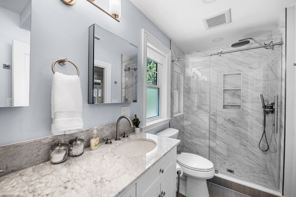 22 Robbins Road Watertown, MA 02472 - Photo 24 of 30 a bathroom with a granite countertop sink toilet and shower