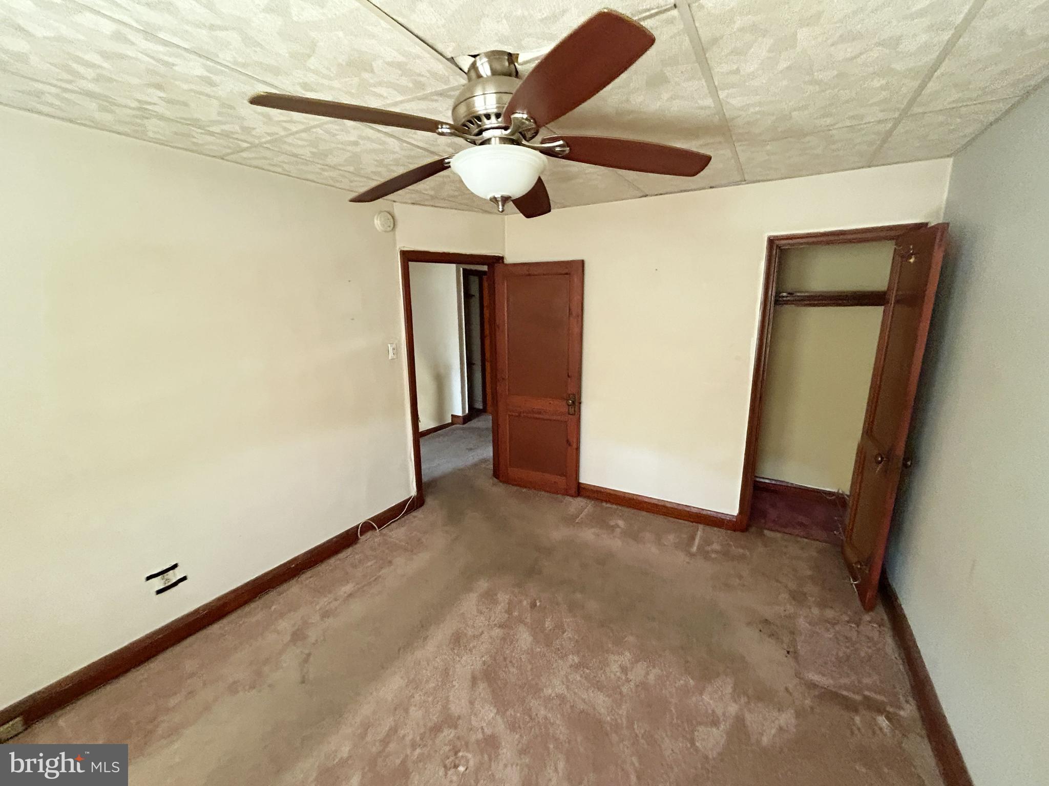 4014 Century Road Baltimore, MD 21206 - Photo 12 of 19 an empty room with a ceiling fan and carpet