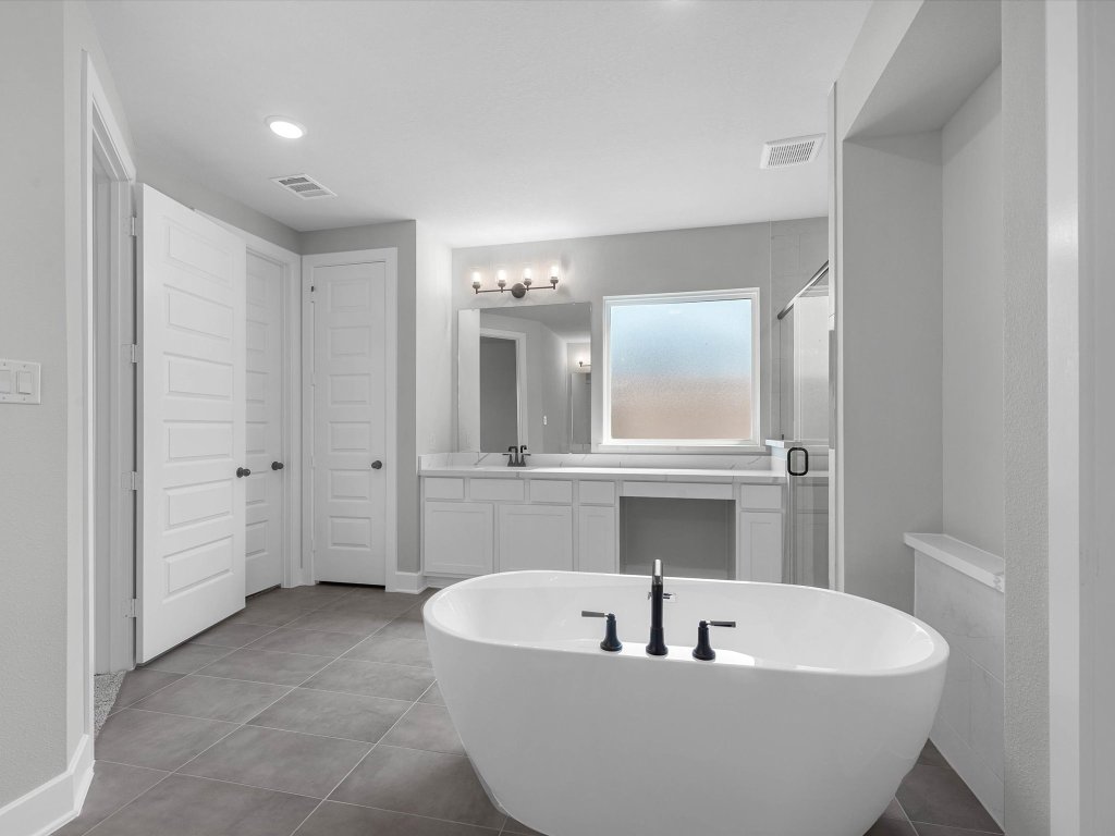 213 Buckaroo Drive Georgetown, TX 78633 - Photo 11 of 22 a white bath tub sitting in a bathroom