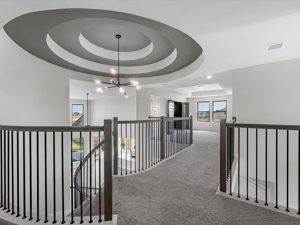 213 Buckaroo Drive Georgetown, TX 78633 - Photo 16 of 22 a view of a hallway with a chandelier