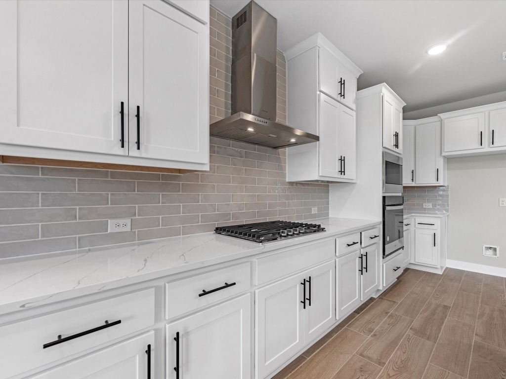 213 Buckaroo Drive Georgetown, TX 78633 - Photo 6 of 22 a kitchen with stainless steel appliances white cabinets and a stove