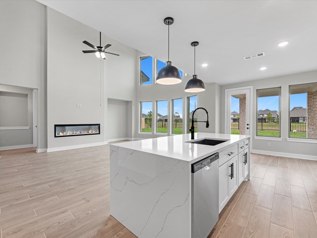 213 Buckaroo Drive Georgetown, TX 78633 - Photo 7 of 22 a large kitchen with stainless steel appliances granite countertop a sink and a large window