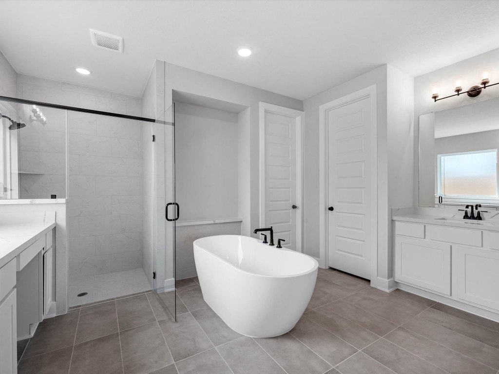 213 Buckaroo Drive Georgetown, TX 78633 - Photo 10 of 22 a spacious bathroom with a bathtub and shower