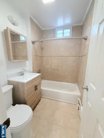 a bathroom with a toilet sink and shower