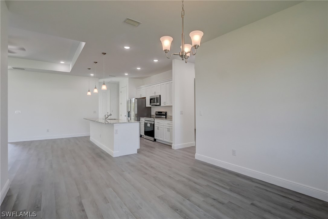 18457 Lee Road Fort Myers, FL 33967 - Photo 12 of 28 a view of kitchen with granite countertop cabinets and refrigerator
