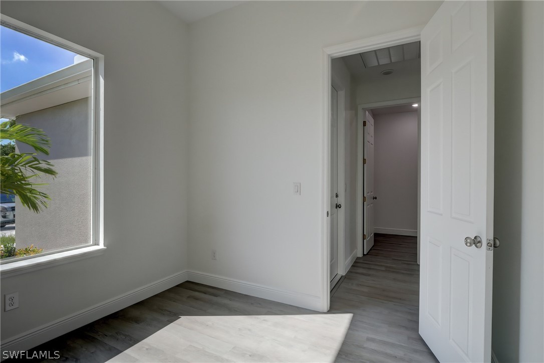 18457 Lee Road Fort Myers, FL 33967 - Photo 17 of 28 a view of a room with wooden floor and a hallway