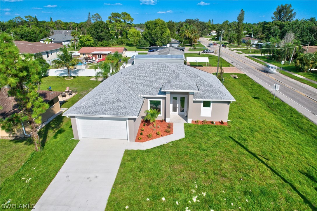 18457 Lee Road Fort Myers, FL 33967 - Photo 3 of 28 a aerial view of a house with swimming pool garden view and a yard