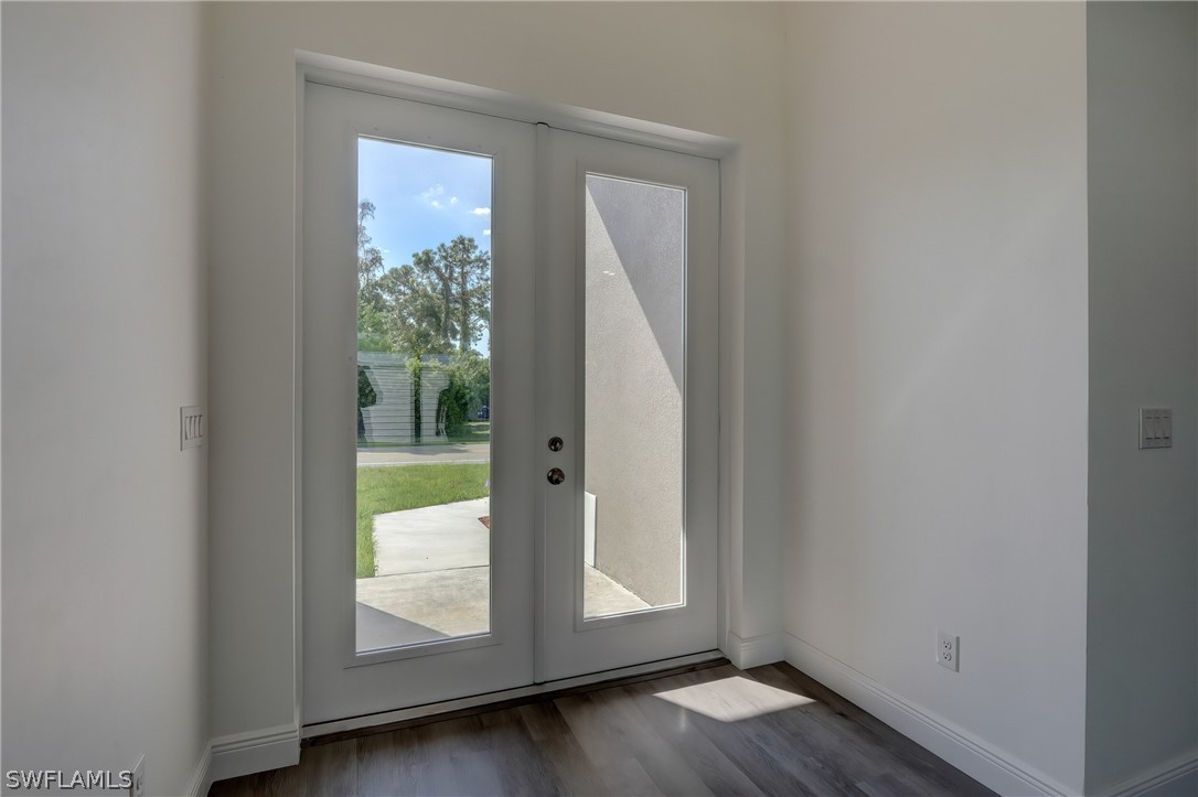 18457 Lee Road Fort Myers, FL 33967 - Photo 8 of 28 a view of an entryway with wooden floor