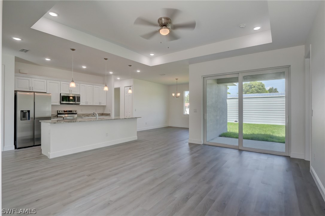 18457 Lee Road Fort Myers, FL 33967 - Photo 9 of 28 a view of kitchen with refrigerator and wooden floor