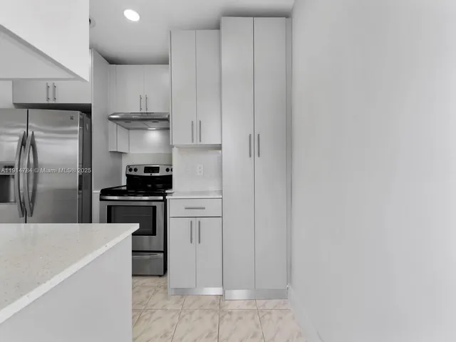 a kitchen with stainless steel appliances a refrigerator and a stove