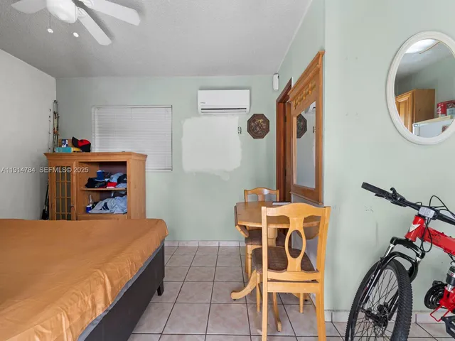 a bedroom with furniture and a mirror