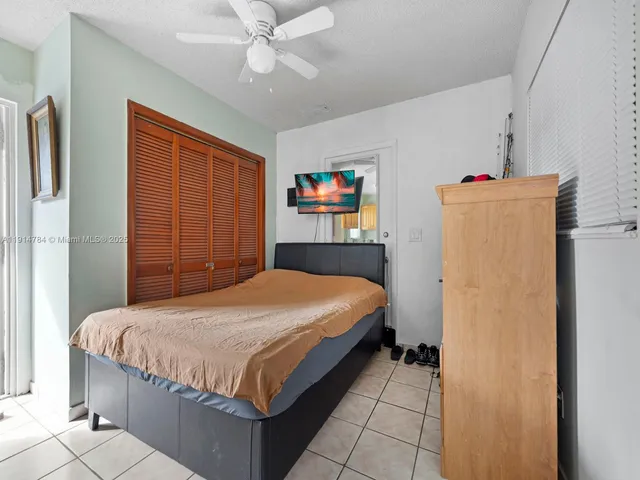 a bedroom with a bed dresser and a window