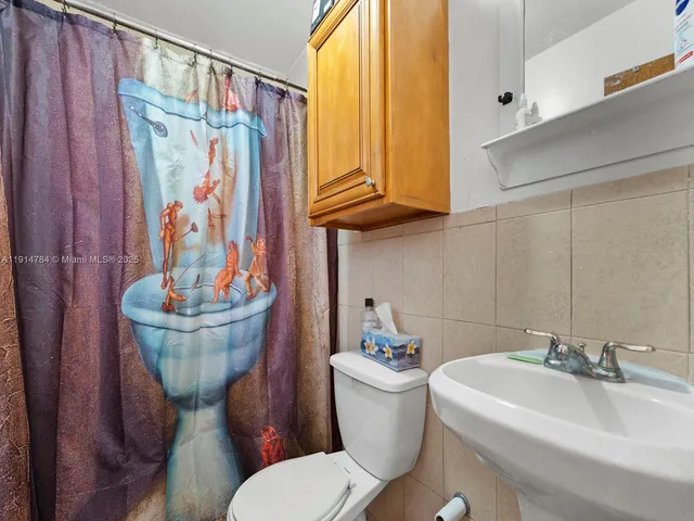 a bathroom with a toilet a sink and a bathtub