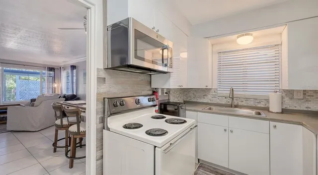 a kitchen with a stove a sink and a microwave